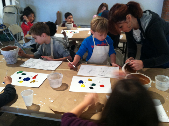 teacher and students painting in art class
