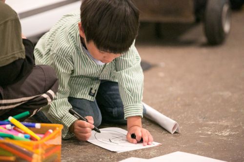 Child drawing during Green Dream's Save the Frogs Day event at The Distillery Gallery in Jersey City. Photo by Danny Chong.