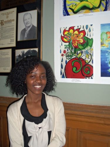 Jersey City student artist, Sarah Mongare with her winning artwork in City Hall