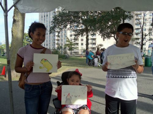 Kids of all ages drawing frogs in the park