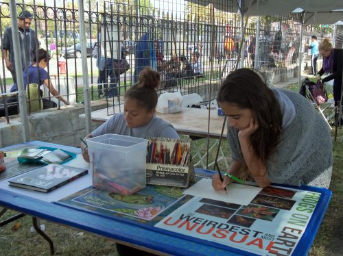 Two young ladies draw frogs at Washington Park Live