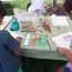 children-drawing-at-frogs-are-green-tent-city-of-water-day-hoboken thumbnail