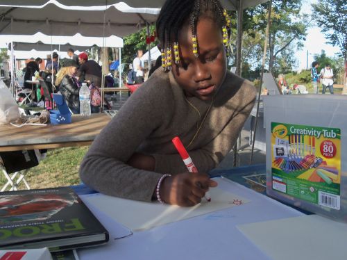 Creating frog art with markers, pencils, crayons, and stickers