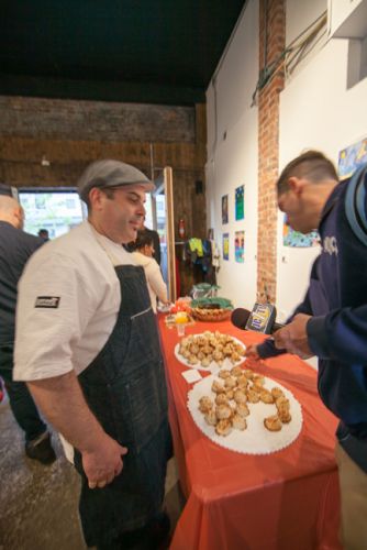 Mayor Steven Fulop samples Chef Camillo Sabella's macaroons at Green Dream's Save the Frogs Day event in Jersey City - Photo by Danny Chong.