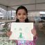 frog-art-and-habitat-displayed-by-girl thumbnail