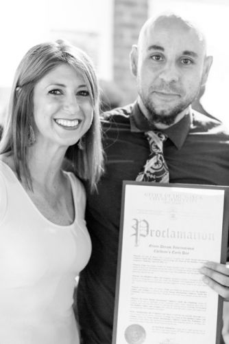 Kristin DeAngelis and Gabriel Pacheco (curators and teachers) show proclamation given by Mayor Steven Fulop at Frogs Are Green's Green Dream - Save the Frogs Day event at The Distillery Gallery. Photo by Danny Chong.