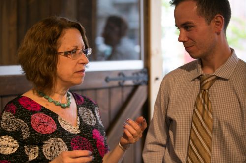 Susan Newman, founder of Frogs Are Green talking with Mayor Fulop's assistant at the Green Dream - Save The Frogs Day event, The Distillery Gallery in Jersey City. Photo by Danny Chong.