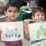 two-boys-display-frog-drawings thumbnail